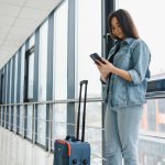 A traveler using safety measures while preparing for a trip, representing the importance of staying alert and prepared for secure and worry-free travel.