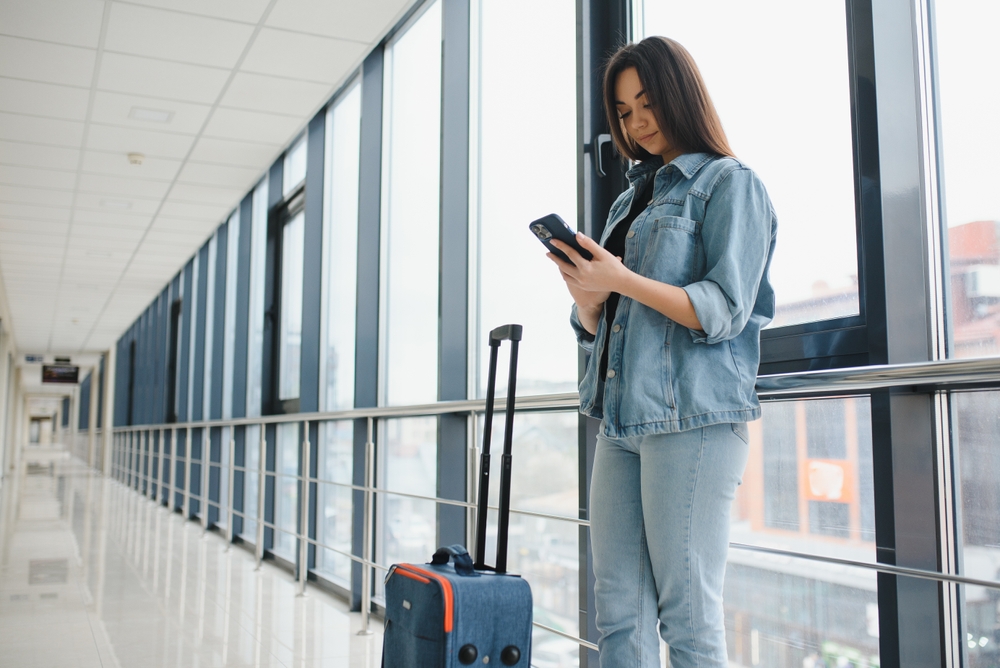 A traveler using safety measures while preparing for a trip, representing the importance of staying alert and prepared for secure and worry-free travel.